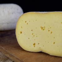Half Rainton Tomme with full cheese behind