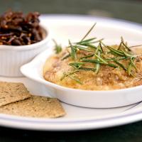 A Baked Bluebell, topped with Rosemary and served with crackers and preserves